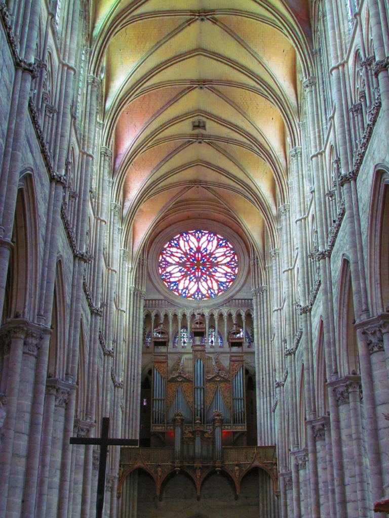 Church Hallway leading to a giant stain Glass window
